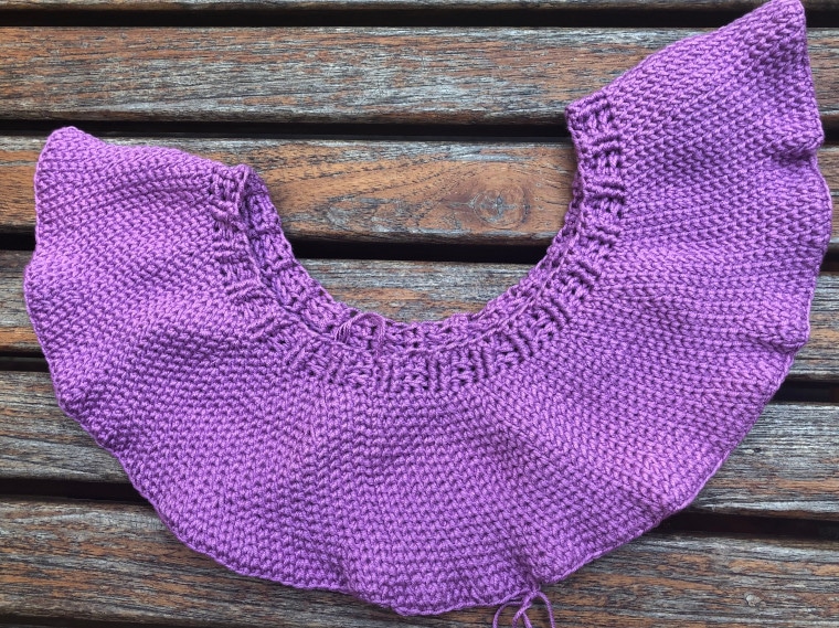 Image of the yoke of the ruffled romance sweater in purple as a work in progress