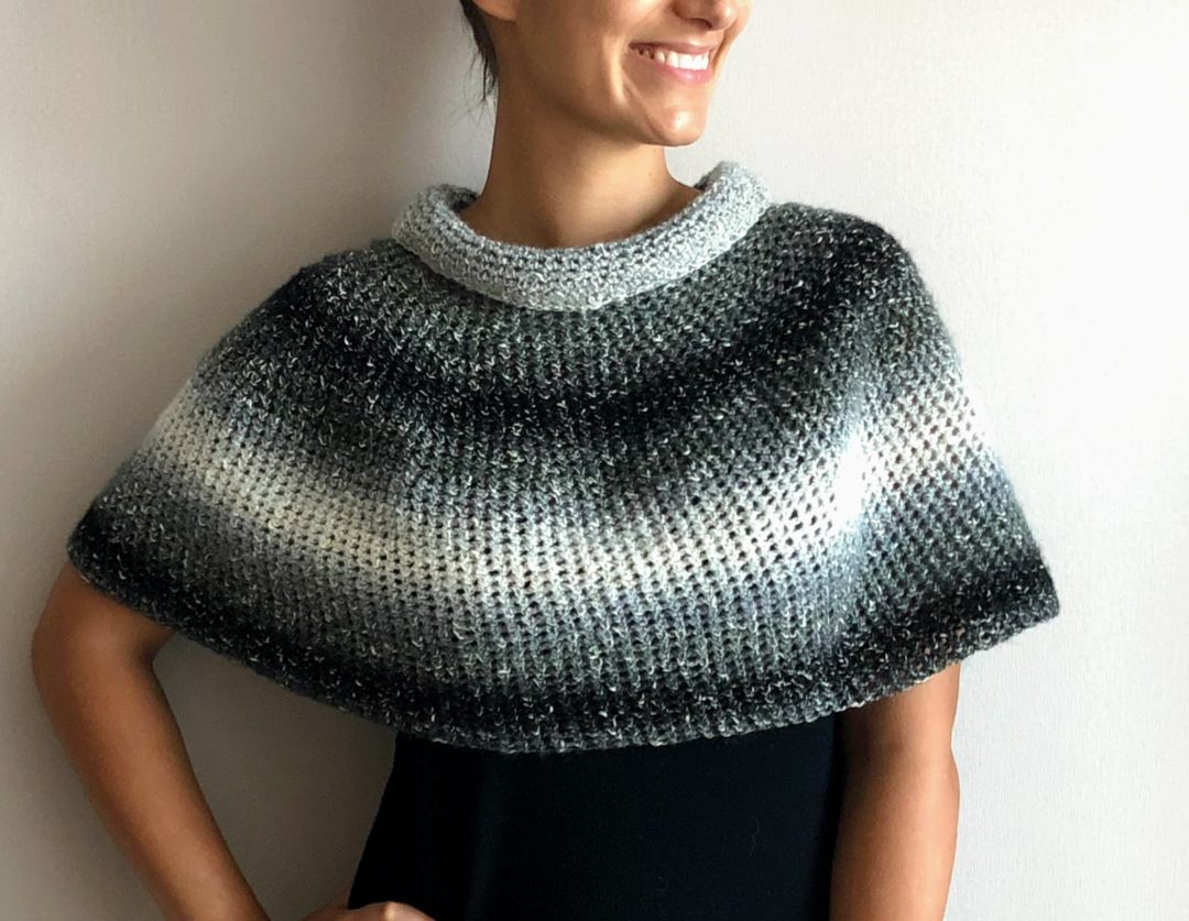 Cover image for the Crochet Silver Lining Capelet with a model wearing the capelet