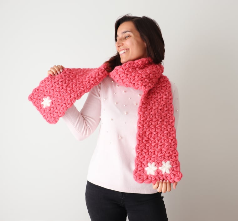 Susana from Fluffy Stitches wearing a bright pink Crochet Jasmine Scarf.