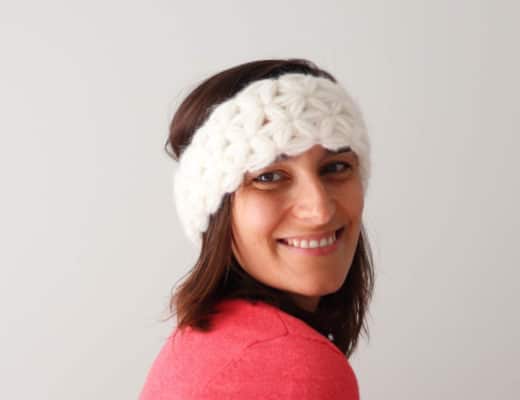 Susana from Fluffy Stitches wearing the Crochet Jasmine Headband with a pink jacket