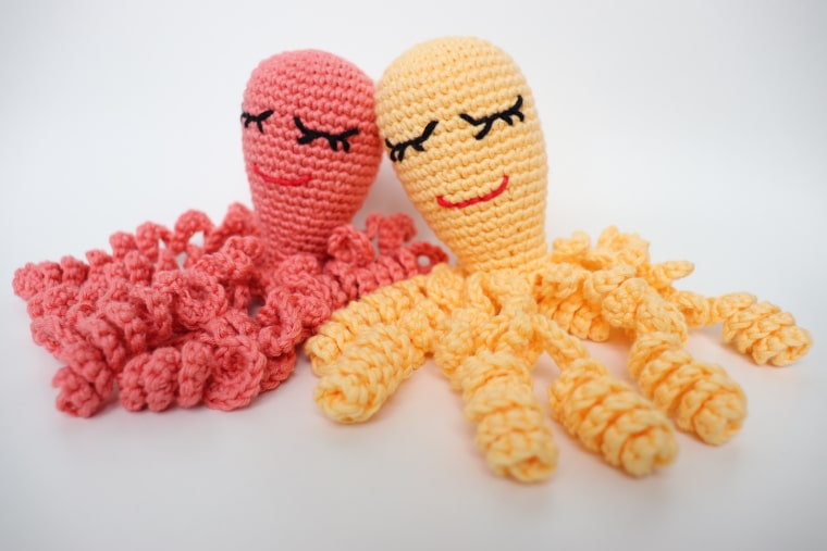 A pink and yellow crochet octopus for a preemie