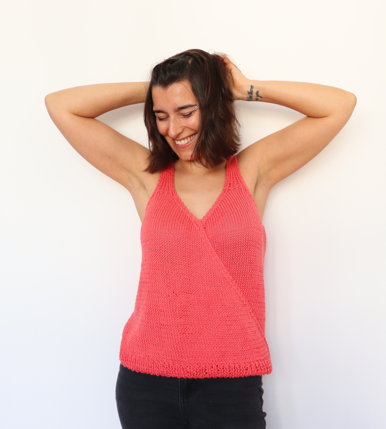 Woman laughing while wearing the Knit Tulip Wrap Tank from Knitatude