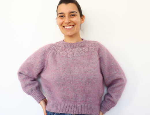 Woman laughing while wearing the Knit Grinalda Sweater by Rosa Pomar